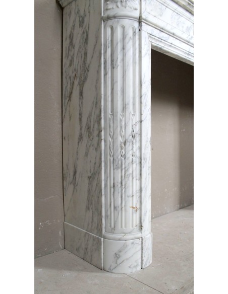Caminetto neoclassico scolpito in marmo Statuario Arabescato, con tenui venature grigie su fondo bianco.