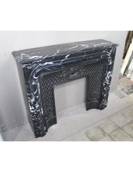 Cornice antica da camino "Boudin Arrondi" in marmo Nero con venature bianche provvista del suo controcuore d'origine in ghisa.