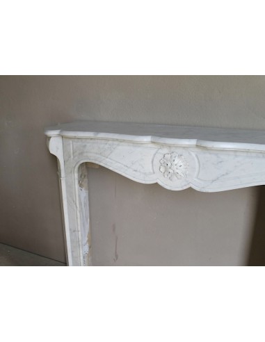 Caminetto antico barocco "Pompadour" scolpito in marmo bianco Carrara recante la scultura di una rosa al centro del frontale.