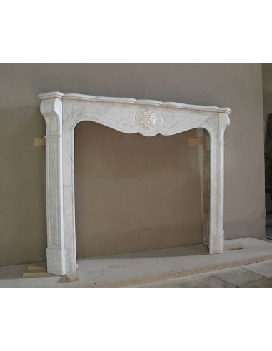 Caminetto antico barocco "Pompadour" scolpito in marmo bianco Carrara recante la scultura di una rosa al centro del frontale.