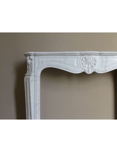 Caminetto Luigi XV "Trois Coquilles" in marmo bianco di Carrara, di stile barocco proposto in offerta a prezzo scontato.