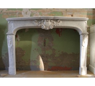 Camino antico in marmo bianco di Carrara, di stile barocco e con un importante carico decorativo.