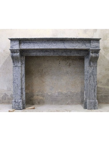 Caminetto antico Luigi Filippo scolpito in marmo grigio fiorito, chiamato "Modillon".